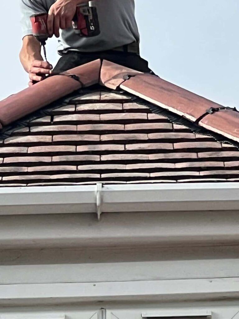 This is a photo of one of the operatives of TRP Roofing Goole installing new ridge tiles